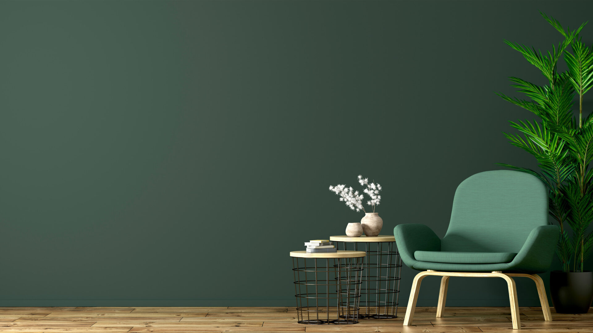 green chair against a dark green wall with plants